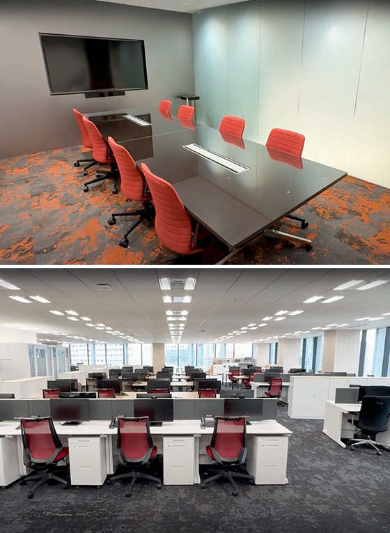 新オフィスの会議室と広々としたフリーアドレス席の全景。